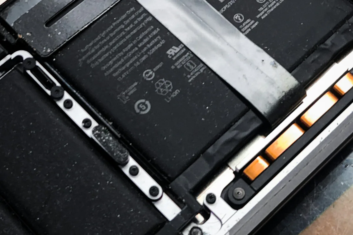 Inside of a laptop with its battery and components exposed