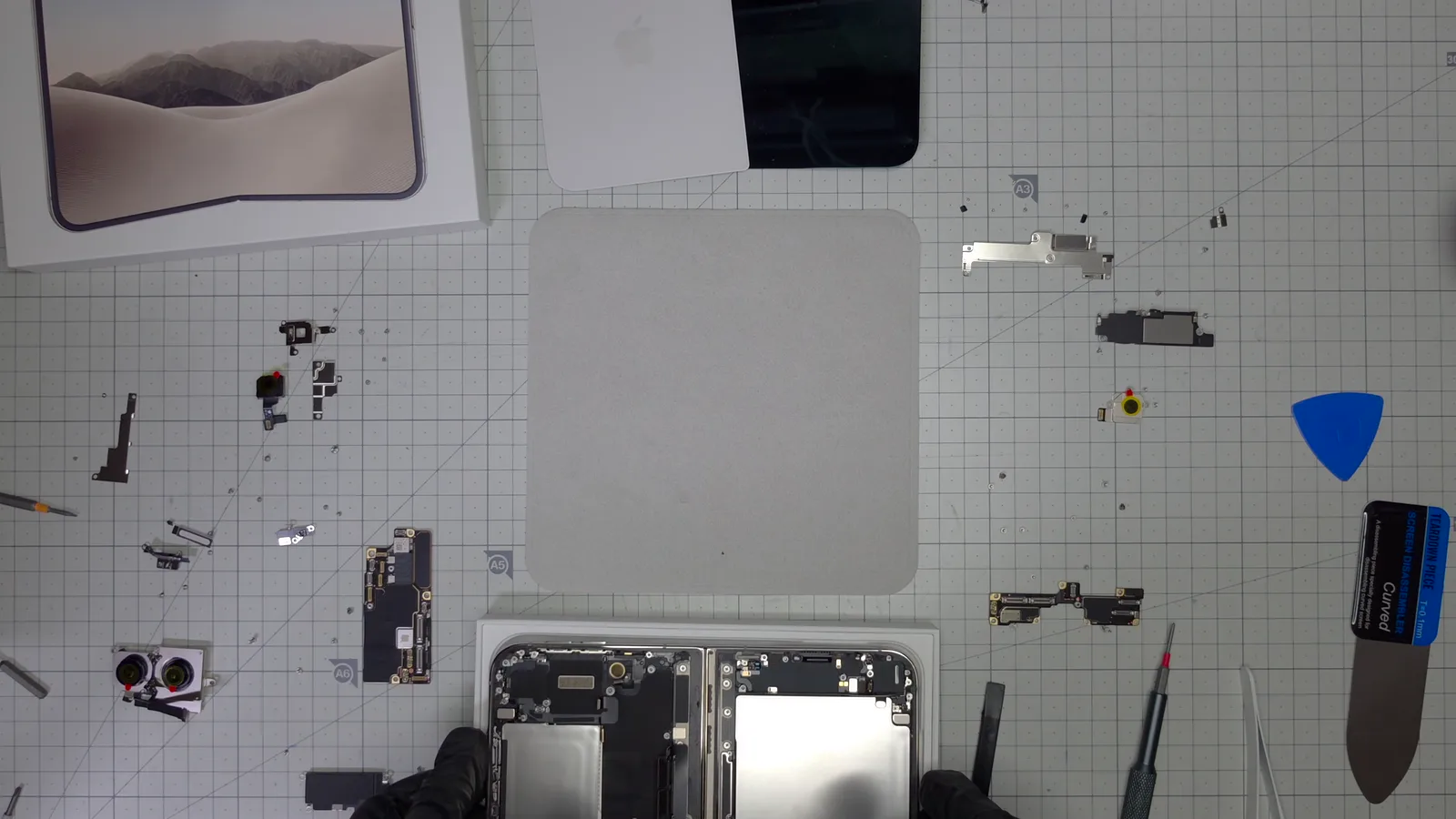 Every part of the iPhone Duo laid out on the cutting mat at the end of the teardown